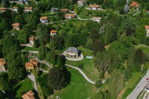 Aerial shot showcasing rural residential houses and lush greenery in a picturesque countryside setting.